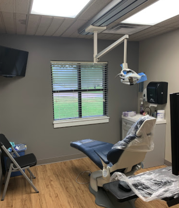 A well-equipped dental office with a chair and dental equipment, ready for patient care.