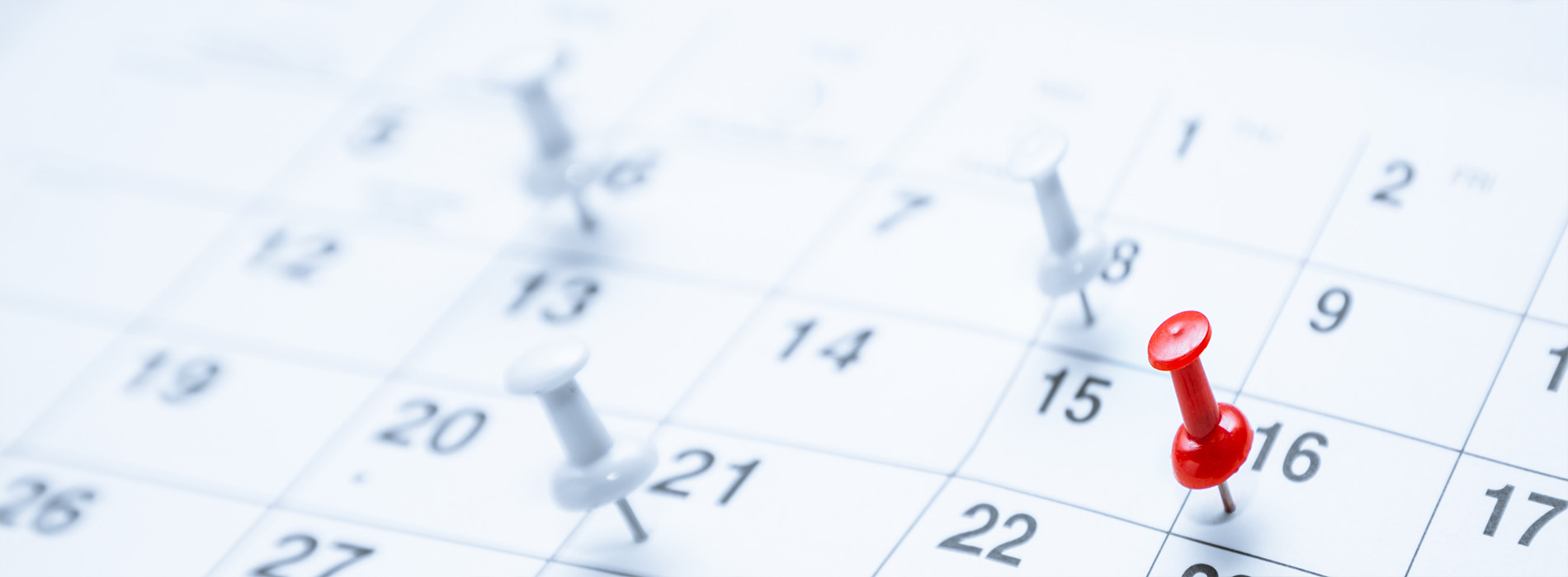 The image shows a calendar with dates highlighted and a red pinpointing a specific date, suggesting an event or reminder for that day.