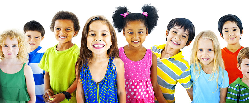 The image depicts a diverse group of children standing together with smiles, wearing colorful clothing and accessories.